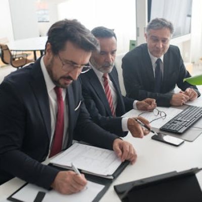 Three professionals collaborating on business plans in modern office.